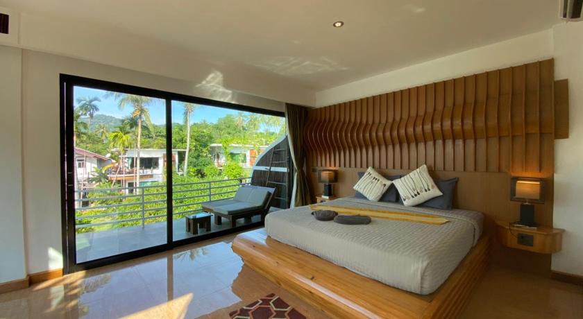 a hotel room with a large bed and a large window, AC 2 Resort in Ko Tao
