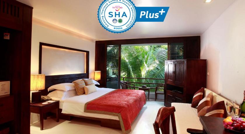 a hotel room with a bed and a table, Safari Beach Hotel (SHA Plus+) in Phuket