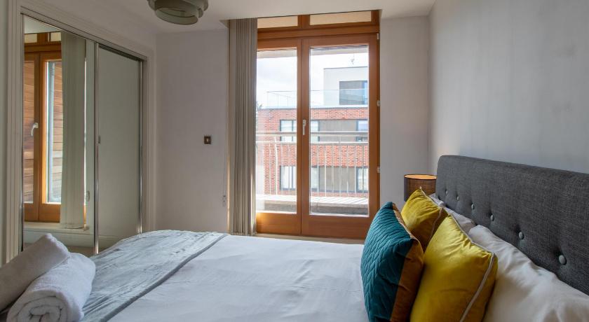 a bedroom with a bed and a window, The Postbox by LFD in Birmingham