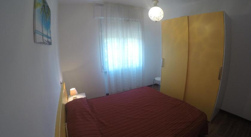 a bedroom with a bed and a lamp, Residence Caorle Apartments in Caorle