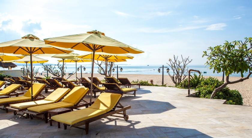 a row of beach chairs with umbrellas on the beach, Allezboo Beach Resort and Spa in Phan Thiet