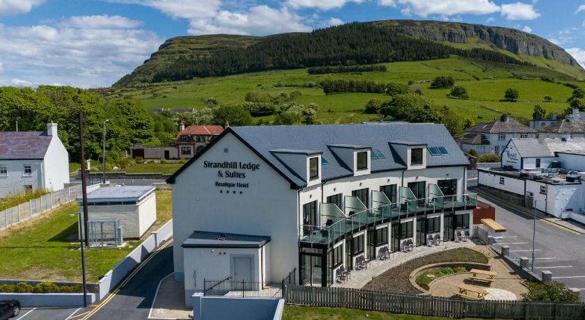 a large building with a sign on the side of it, Strandhill Lodge and Suites in Sligo