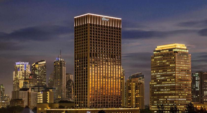 a city at night with tall buildings and skyscrapers, Fairmont Jakarta Hotel in Jakarta