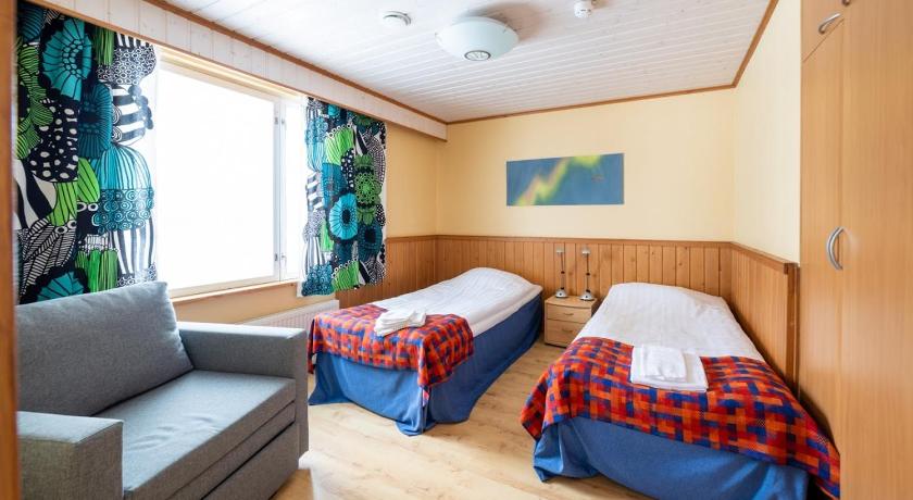 a bed room with two beds and a desk, Hotel Utsjoki in Utsjoki