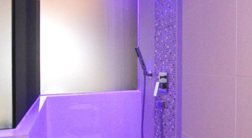 a bathroom with a blue and white shower curtain, Arton Boutique Hotel (SG Clean Certified) in Singapore