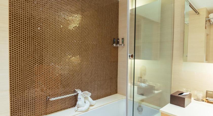 a bathroom with a shower, sink, and mirror, Novotel Lucknow Gomti Nagar in Lucknow