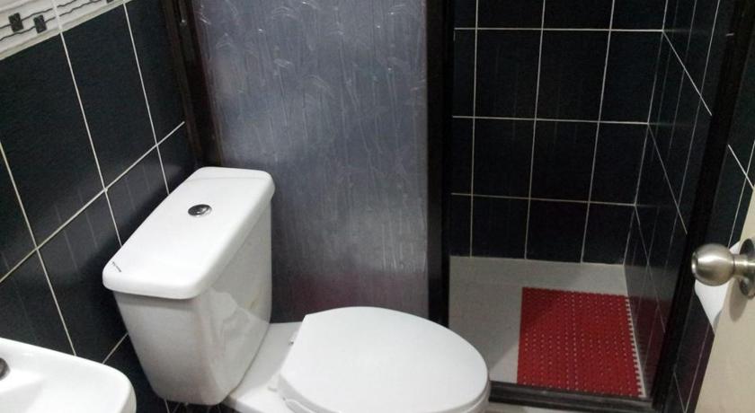 a bathroom with a toilet and a sink, Lyn's Do Drop Inn in Baguio