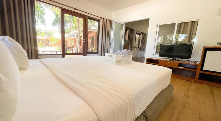a hotel room with two beds and a television, Samed Cabana Resort (SHA Extra Plus) in Ko Samet