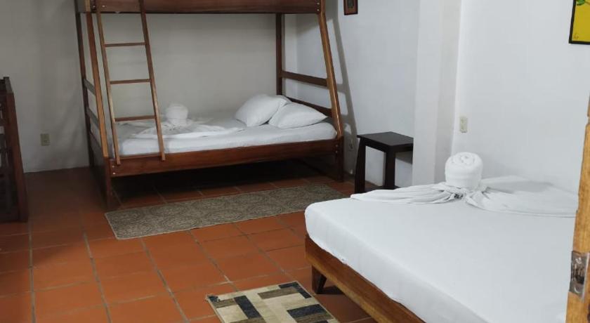 a bedroom with a bed and a desk, Casa Marbella in Tortuguero