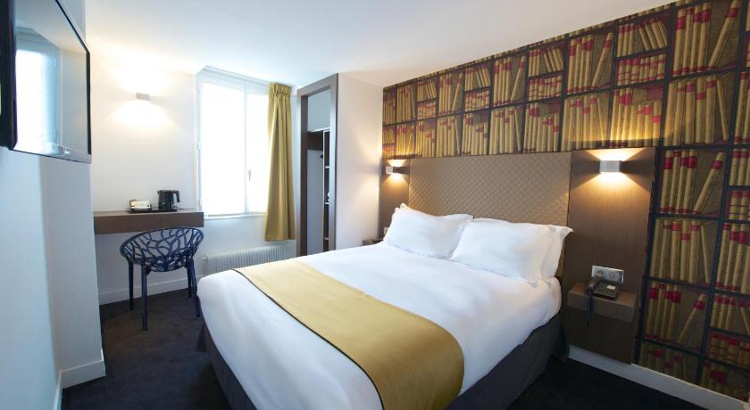 a hotel room with a bed and a desk, Hotel de la Gaite in Paris
