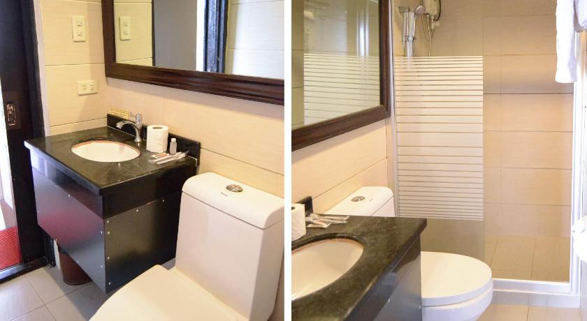 a bathroom with a toilet, sink and mirror, OYO 791 Bell Mansion in Manila