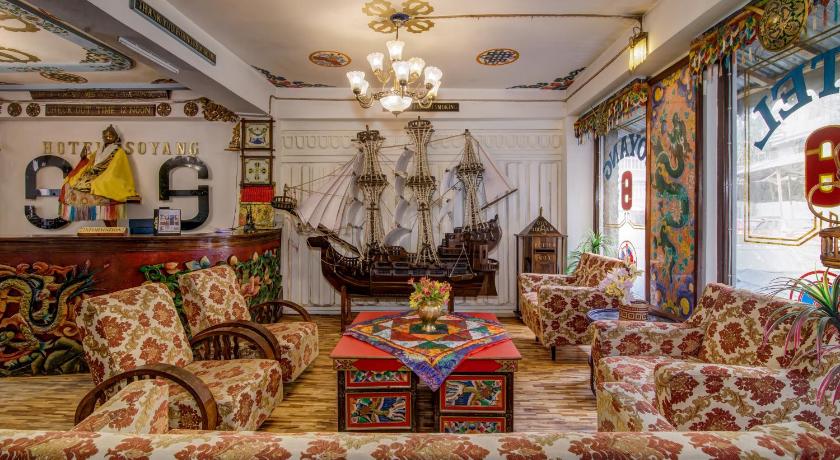 a living room filled with furniture and decorations, Montis Soyang Premium Heritage Hotel in Gangtok