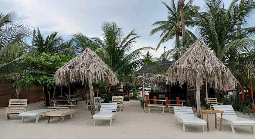 a beach filled with palm trees and palm trees, SF Cantina Hotel in Cebu