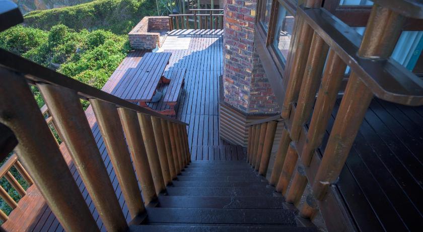 a staircase leading up to a balcony overlooking a garden, Shamrock Cottage in Eersterivierstrand