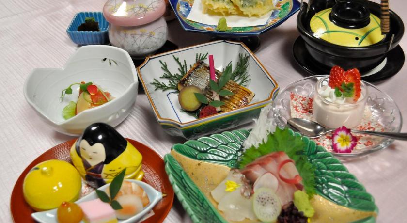a table topped with plates of food, Kurayoshi City Hotel in Kurayoshi