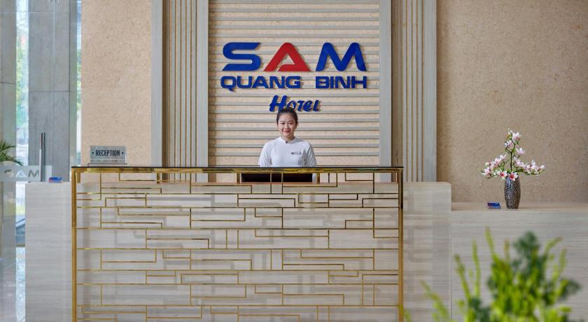 a man sitting in front of a wall with a sign on it, SAM Quang Binh Hotel in Đồng Hới (Quảng Bình)