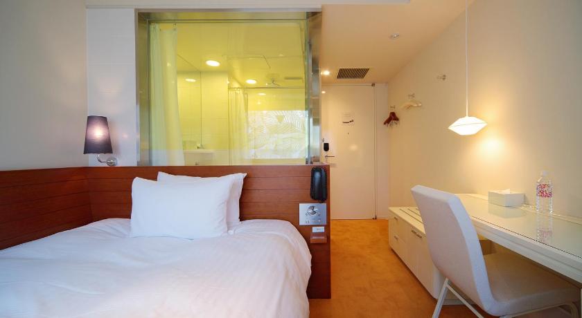 a bedroom with a white bed and white walls, Shibuya Granbell Hotel in Tokyo