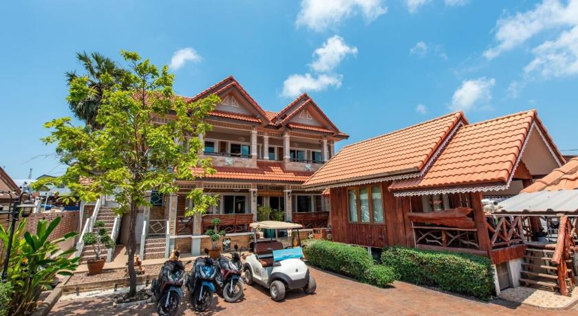 a large building with a motorcycle parked in front of it, Baan Virog Kohlarn in Pattaya