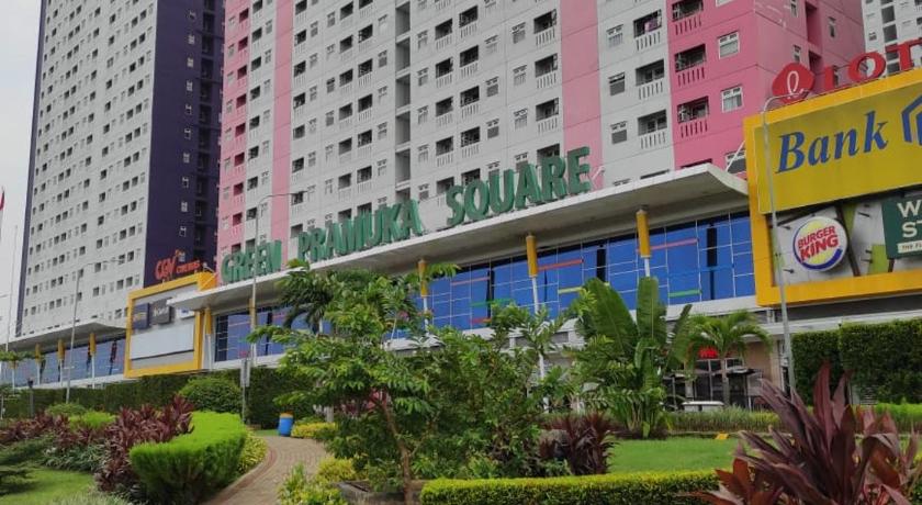 a large building with a lot of trees, 2BR Green Pramuka Apartment in Jakarta