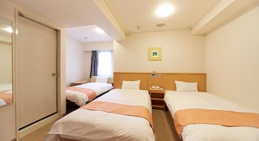 a hotel room with two beds and a desk, Nest Hotel Kumamoto in Kumamoto