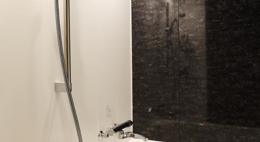 a bathroom with a shower and a sink, LOF Hotel Shimbashi in Tokyo