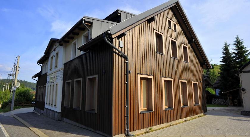a large brick building with a large window, Chata Vermont in Bedrichov U Jablonce Nad Nisou