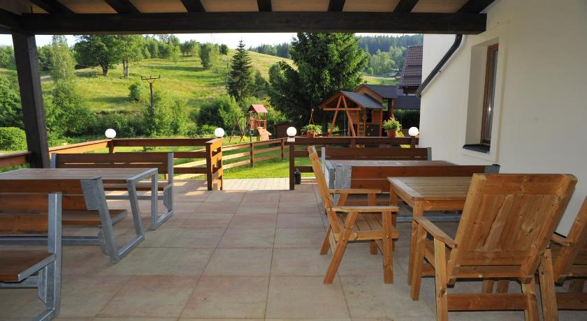 a patio area with chairs, tables, and tables, Chata Vermont in Bedrichov U Jablonce Nad Nisou