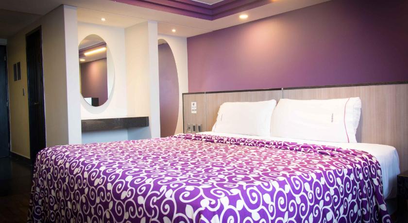 a hotel room with a large bed and a large window, Hotel MaxIntimo in Mexico City