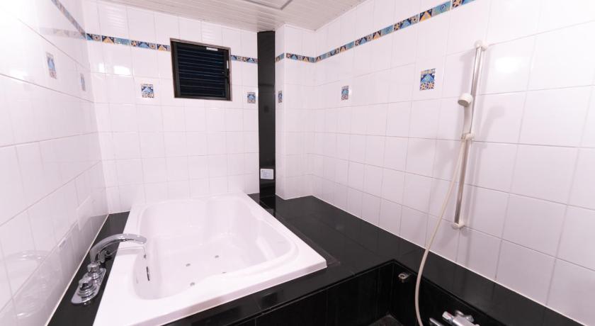 a bathroom with a shower stall and a sink, HOTEL Rplus日高 in Hanno