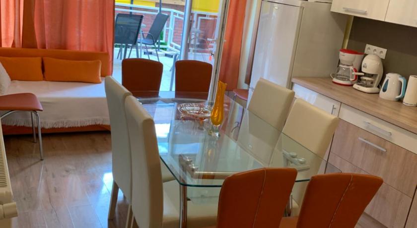 a dining room table and chairs in a room, Martina Apartmanhaz in Balatonlelle
