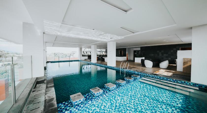 a swimming pool filled with lots of towels and chairs, Apartemen Tera Residence in Bandung