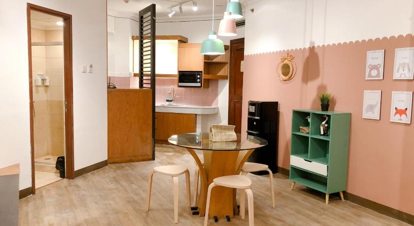 a kitchen with a table, chairs and a refrigerator, youre at - Grand Setiabudhi Apartment in Bandung
