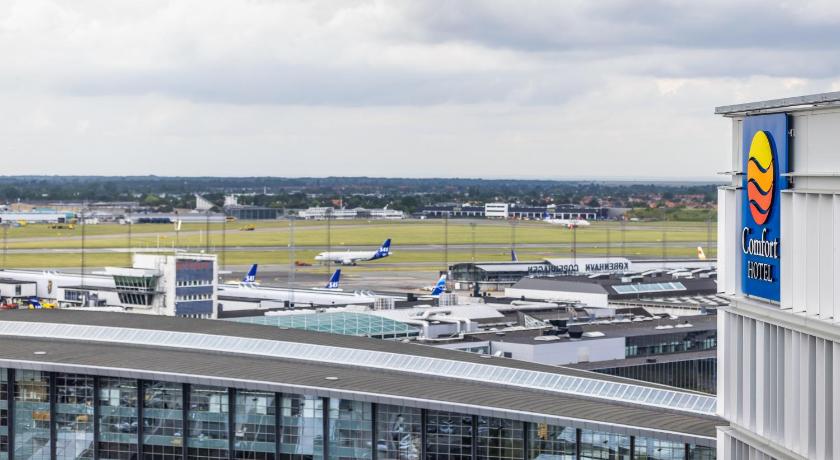 a large jetliner sitting on top of an airport tarmac, Comfort Hotel Copenhagen Airport in Copenhagen