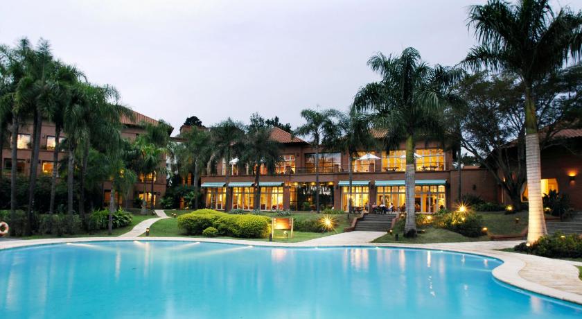 a large swimming pool in front of a large house, Iguazu Grand Resort Spa & Casino in Puerto Iguazu