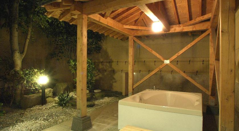 a bath room with a tub and a fire place, Color Hotel (Love Hotel) in Kumamoto