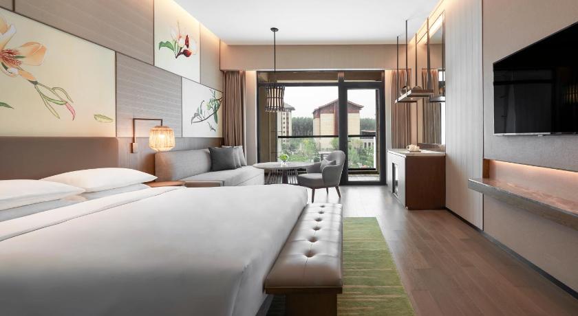 a hotel room with two beds and a tv, Hyatt Regency Beijing Shiyuan in Beijing