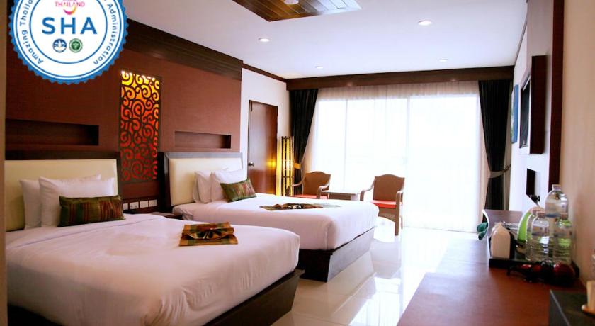 a hotel room with a large bed and a large window, Chivatara Resort Bang Tao Beach Phuket in Phuket
