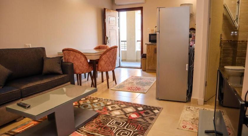 a living room filled with furniture and a refrigerator, لونج ايلند in Marsa Matruh