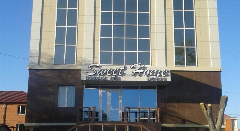 a building with a sign on the front of it, Sweet Home Hotel in Atyrau