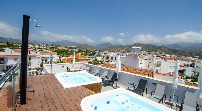 a hotel room with a pool and a balcony overlooking the ocean, NERJA-CENTRO-JACUZZI- MIRADOR DE LA ERMITA- Adults Recommended in Nerja