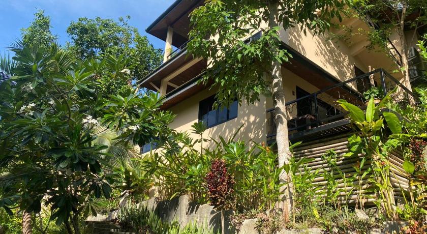 a house that has a tree in front of it, Koh Tao Heights Apartments in Ko Tao