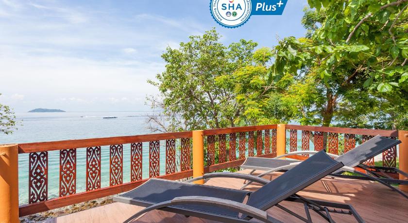 a bench sitting on top of a dock next to a beach, Phi Phi Natural Resort (SHA Extra Plus) in Ko Phi Phi