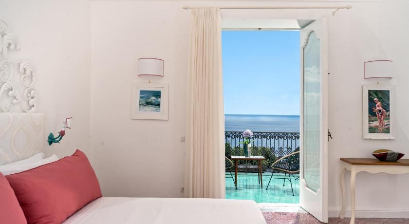 a hotel room with a view of the ocean, Hotel Punta Regina in Positano