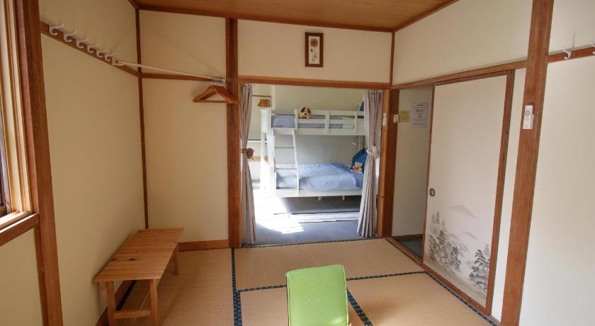 a small kitchen with a refrigerator and a sink, Myoko Mountain Lodge in Itoigawa