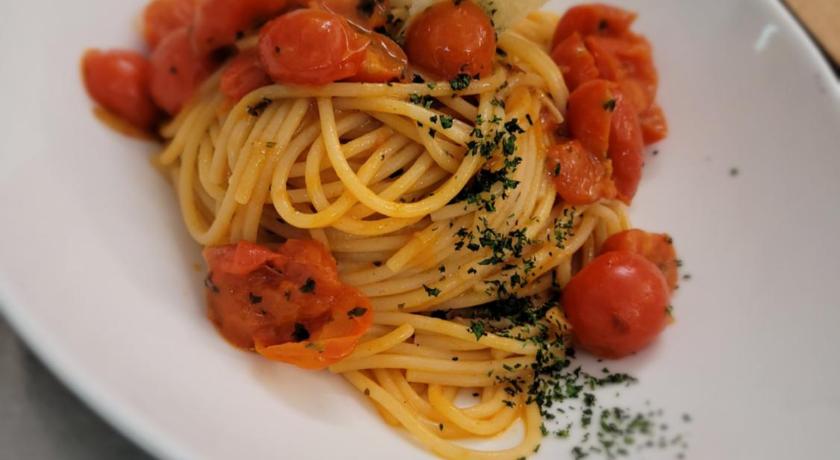 a white plate topped with pasta and vegetables, Hotel Elimo in Trapani