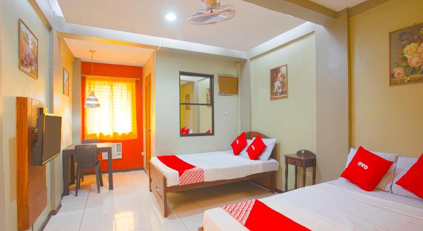 a hotel room with two beds and a television, OYO 802 Ka Farah's Inn in Antipolo