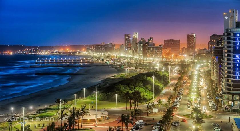 a city at night with a large body of water, Blue Waters Hotel in Durban