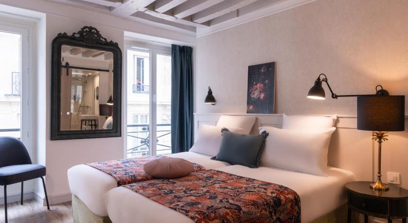 a bedroom with a large bed and a large window, Hotel Touraine Opera in Paris