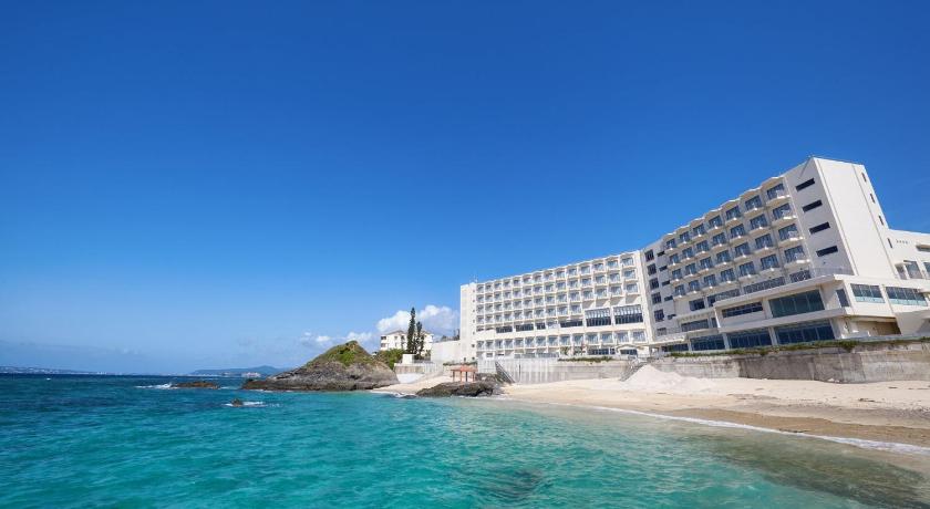 a large white building with a blue ocean view, Hotel Miyuki Beach in Okinawa Main island