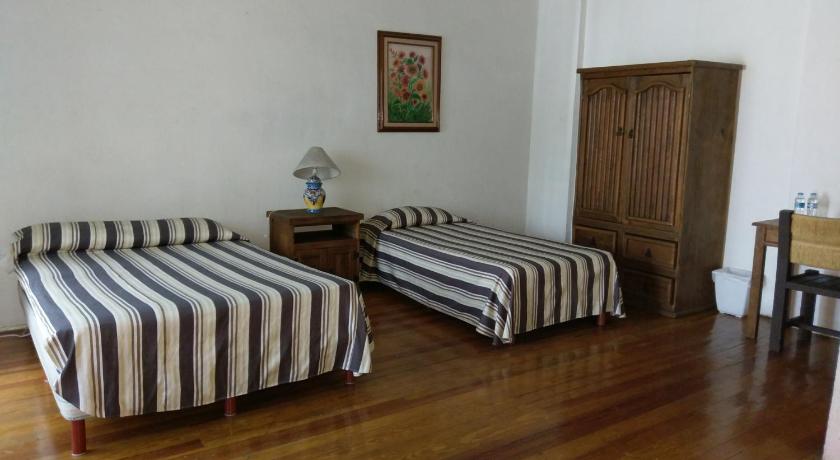a hotel room with two beds and a desk, Anys Hostal in Mexico City
